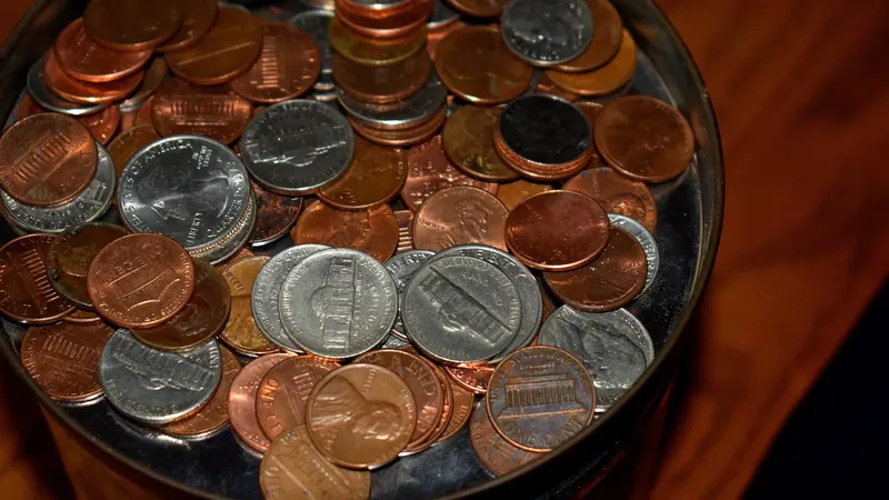 Close-up of a glass jar filled with U.S. pennies, nickels and other coins saved as a cash reserve